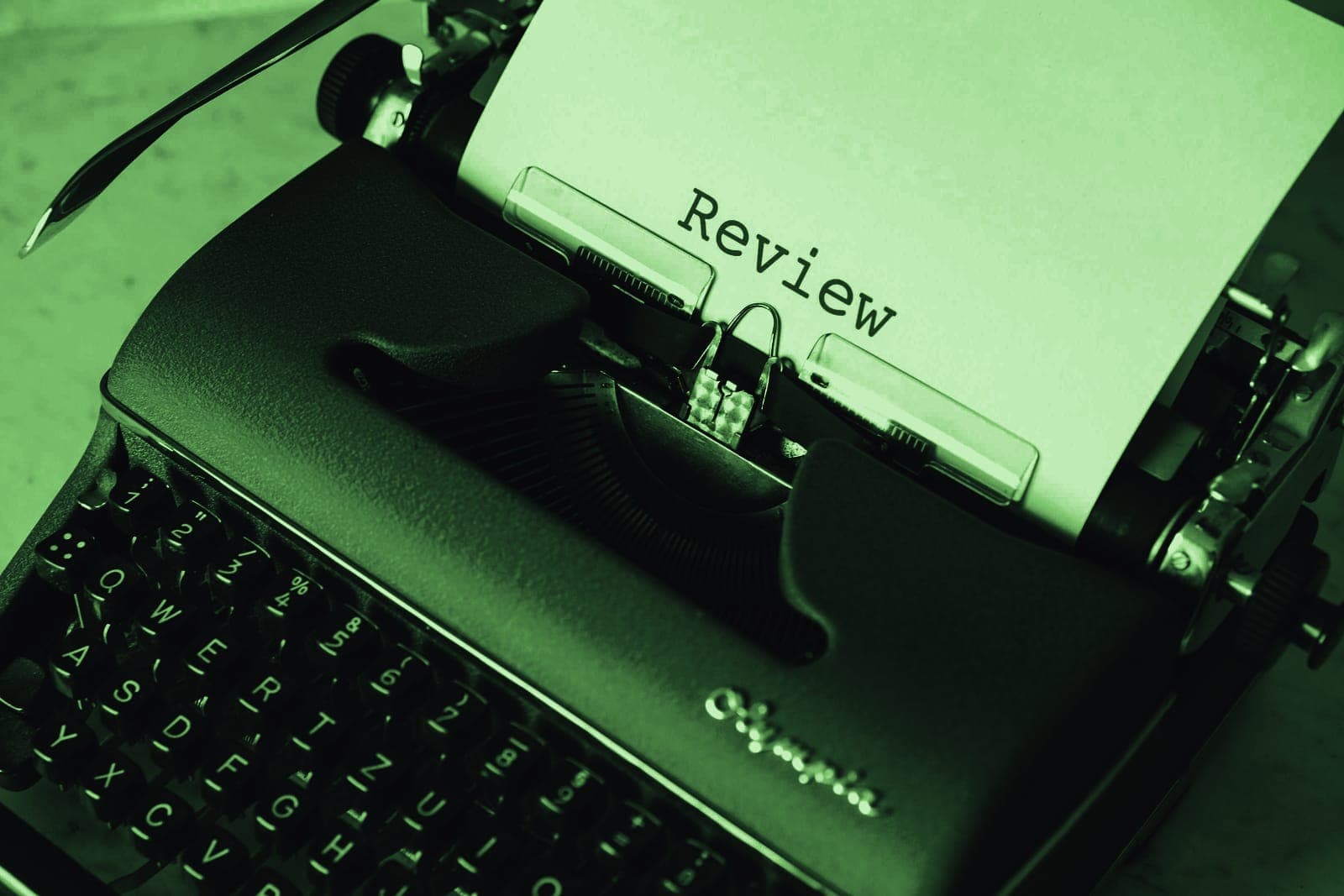 A typewriter with the word review typed on the page